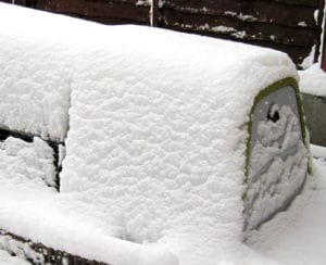 An Eglu Go hutch covered in snow