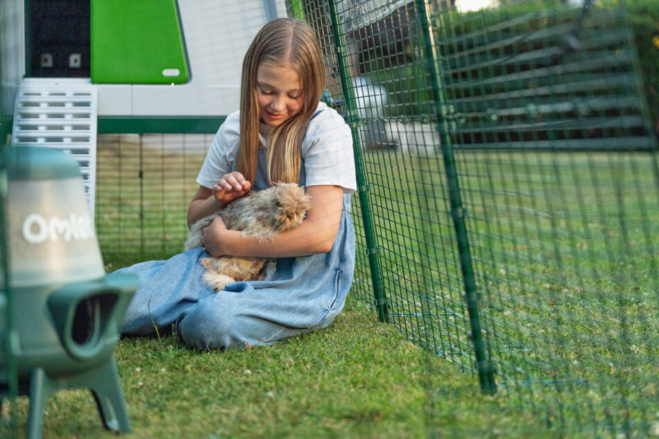 Girl holding chicken in Omlet Eglu Cube Run