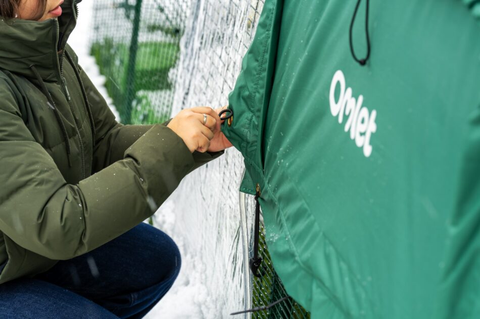 woman attaching extreme temperature jacket to eglu pro