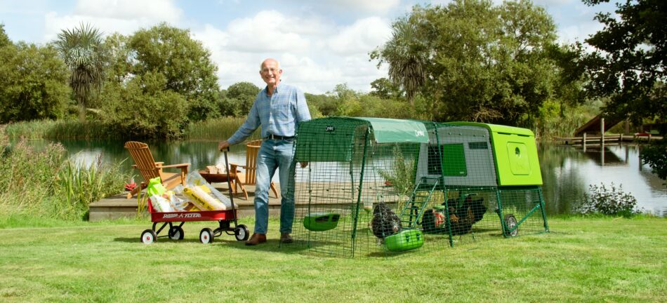 Man with Omlet Eglu Cube chicken coop and accessories 