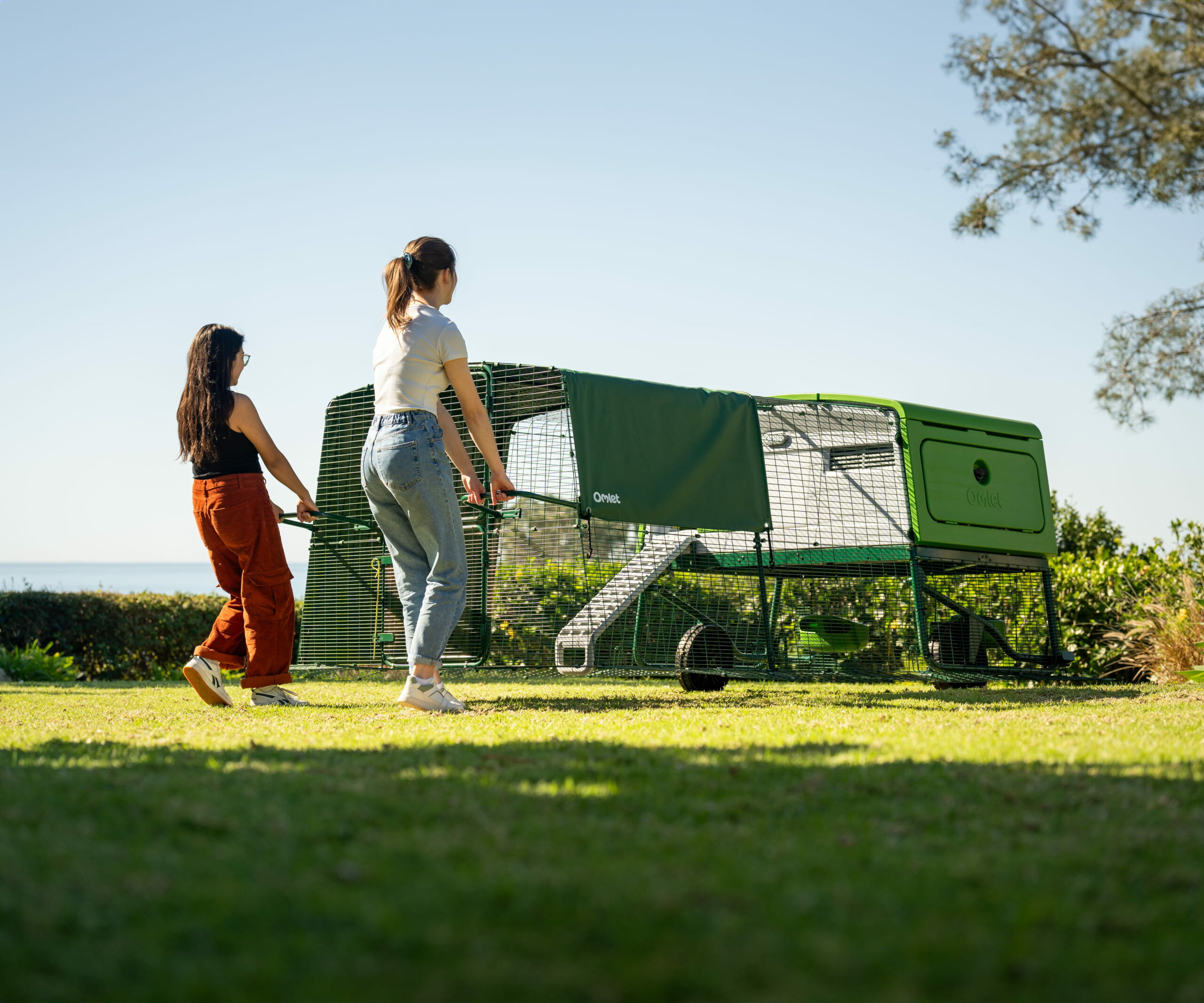two women moving the eglu pro chicken coop